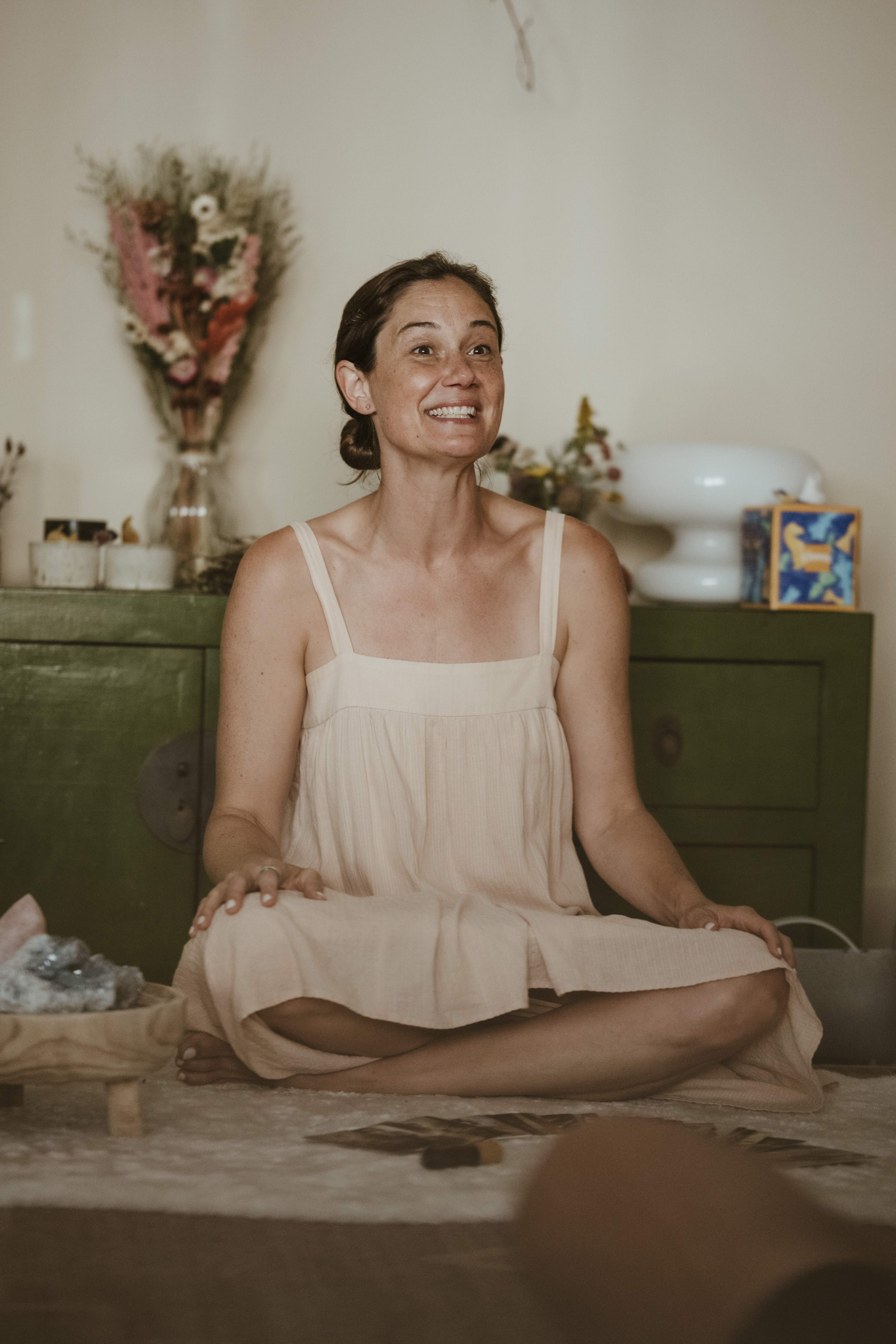 Blair Cobb smiling in a warm, plant-filled studio